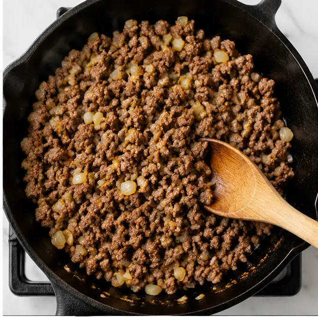 Step 2: Browning the ground beef with onions in a cast-iron skillet