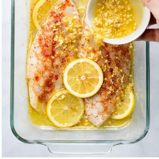 Step 2: Pouring the lemon butter garlic sauce over the fish