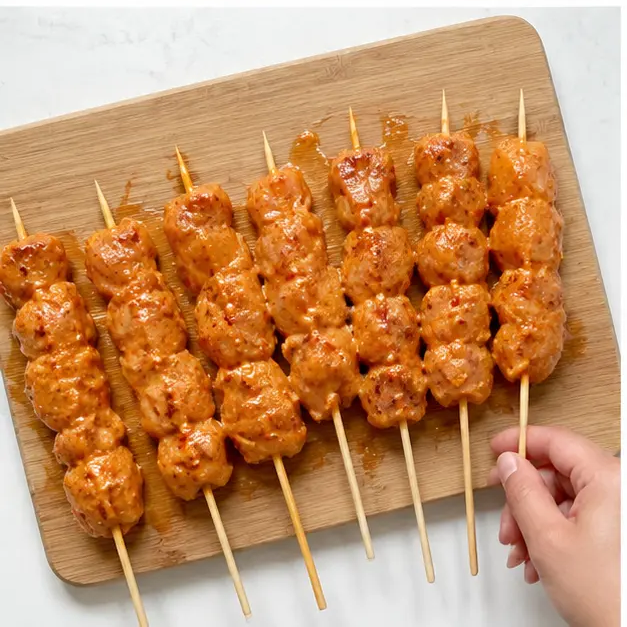 Step 3: Threading marinated chicken onto skewers