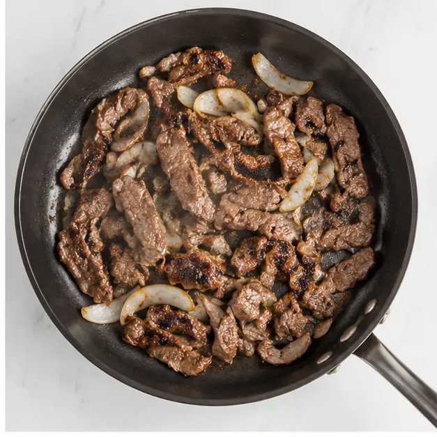 Step 2: Browning the steak pieces in hot oil until golden