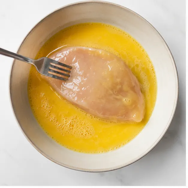 Step 1: Dipping chicken fillet in egg wash