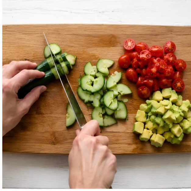 Step 2: Dice cucumbers, halve tomatoes, cube avocados