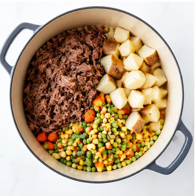 Step 3: Add shredded beef and vegetables to pot