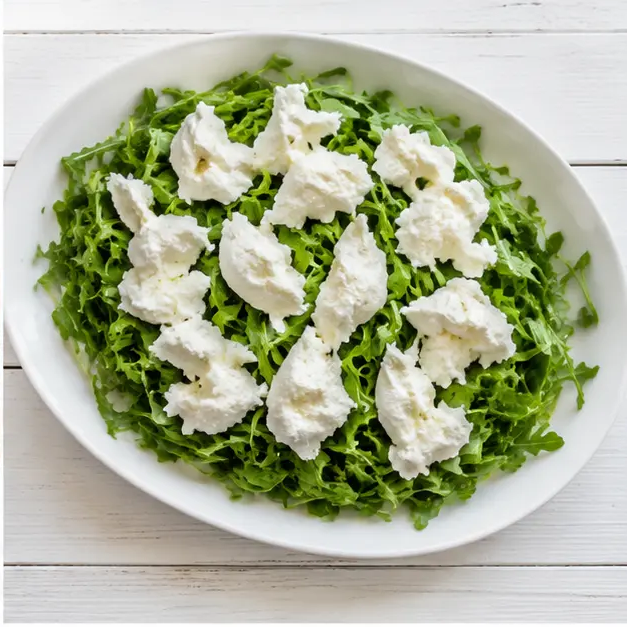 Step 2: Tearing burrata onto arugula bed