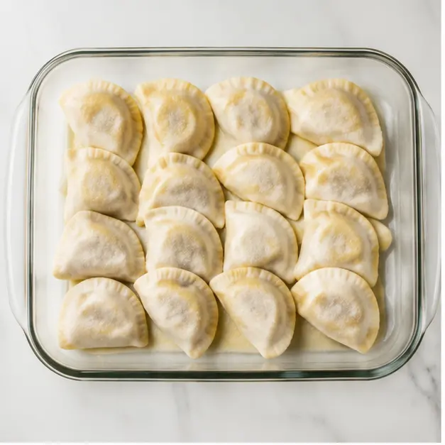Step 1: Layering frozen pierogi in the dish