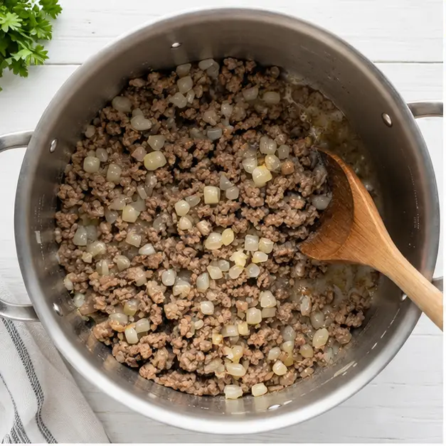 Step 1: Browning ground beef and onion in Dutch oven