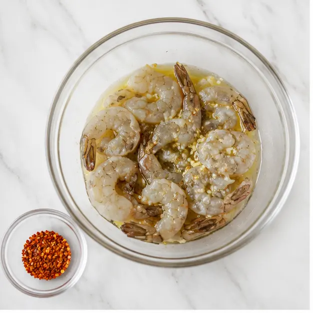 Step 1: Marinate the shrimp in olive oil and garlic
