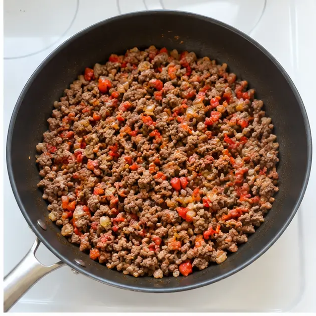 Step 2: adding dry pasta and liquids to the skillet