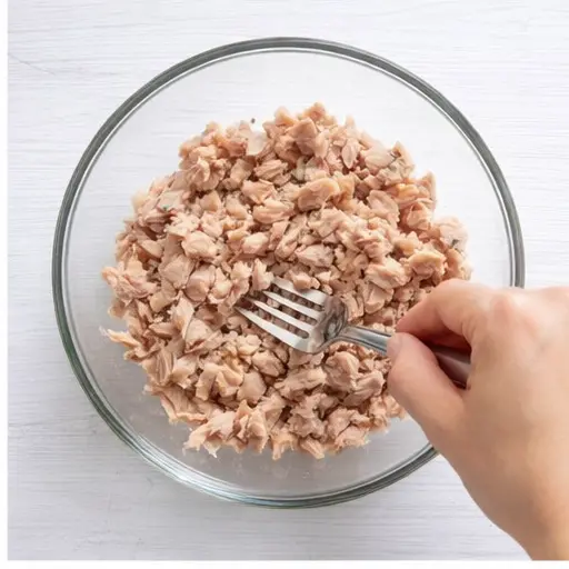 Step 2: Flaking the tuna into a bowl