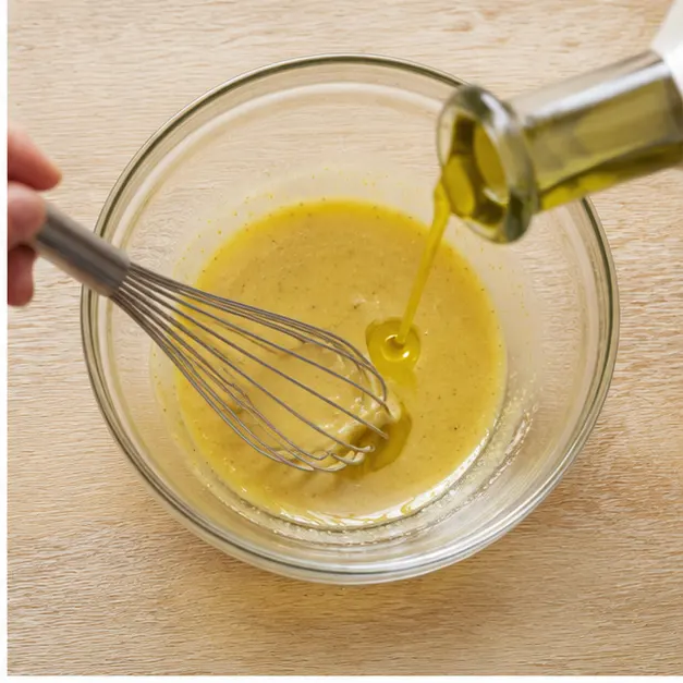 Whisk Dijon mustard, maple syrup, vinegar, and olive oil into a creamy dressing