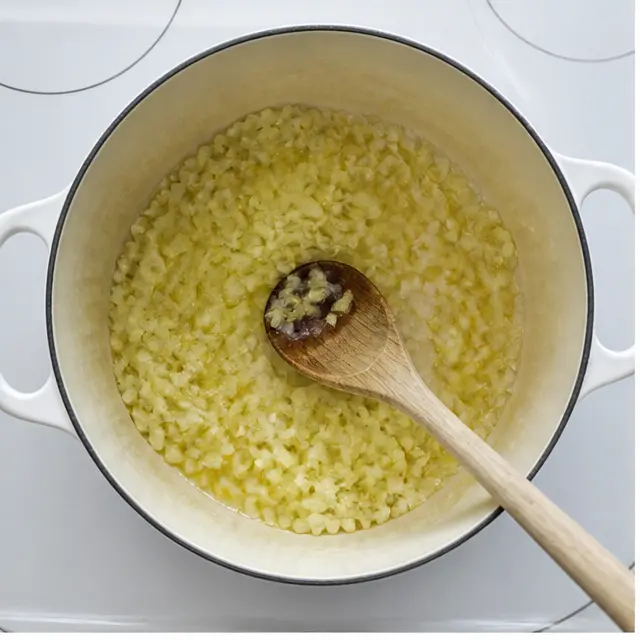Step 1: Sautéing chopped yellow onion in olive oil until translucent