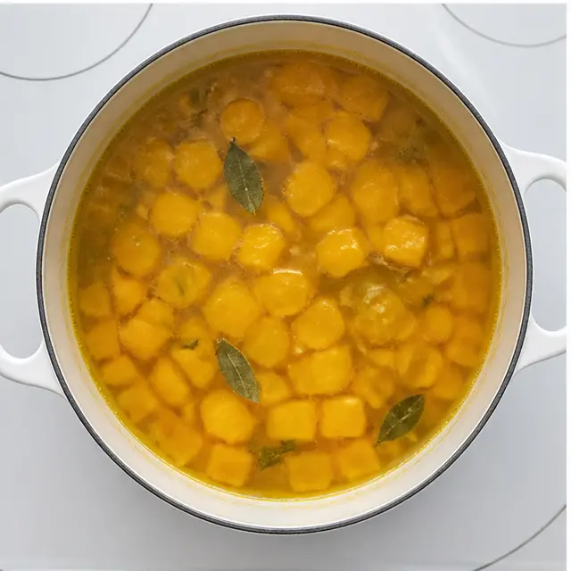 Step 3: Simmering the squash in vegetable broth until fork-tender