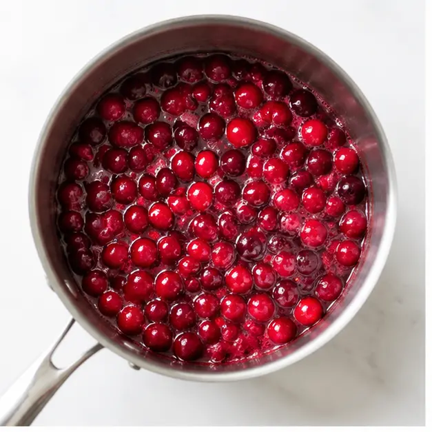 Simmer cranberries with orange juice until they burst