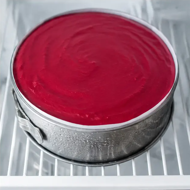 Step 4: Spreading the ruby cranberry mousse over the chilled cheesecake layer