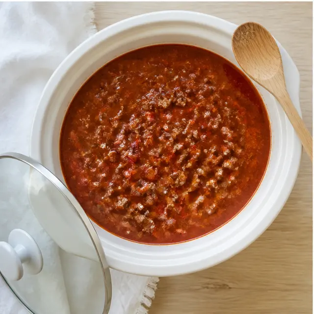 Simmering rich red tomato broth with beef in the slow cooker
