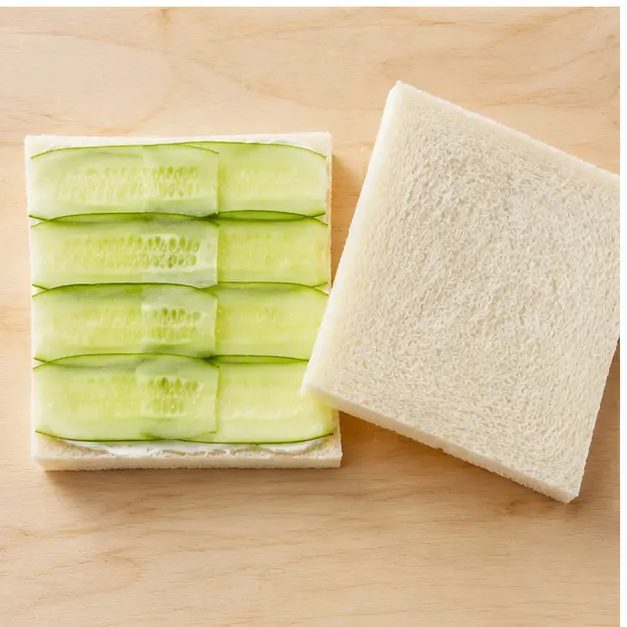 Step 3: Layer cucumber slices overlapping on half the bread