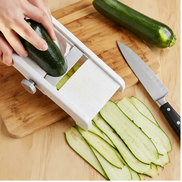 Step 1: Slicing zucchini into thin strips with a mandoline