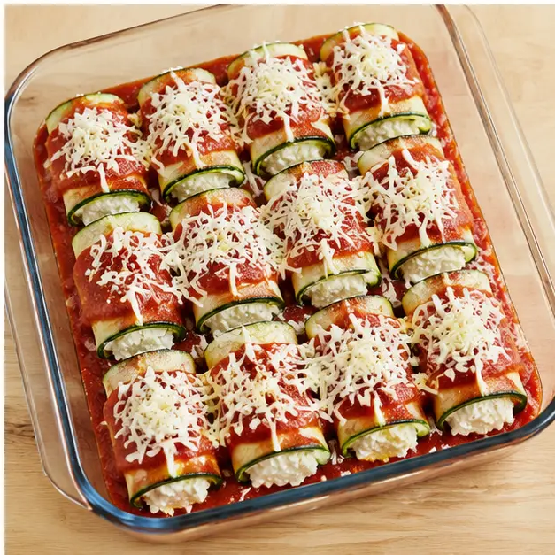 Step 4: Assembling rolls in the baking dish with sauce and cheese