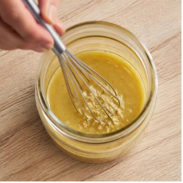Step 1: Whisking the Italian-style dressing in a mason jar