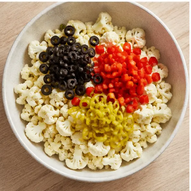 Step 3: Adding olives, peppers, and onion to the cauliflower