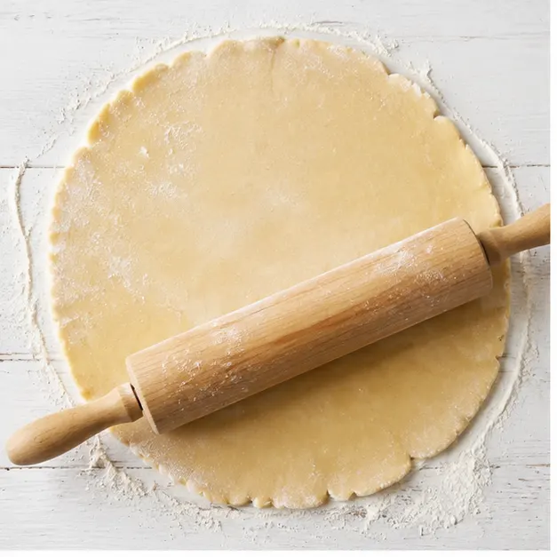 Rolling out the refrigerated pie dough into a 14-inch round