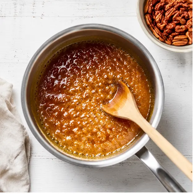 Melt unsalted butter, light brown sugar, and maple syrup into a bubbling golden caramel glaze in a small saucepan