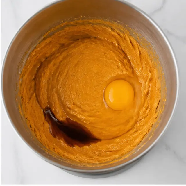 Step 2: Mixing in pumpkin, vanilla, and egg.