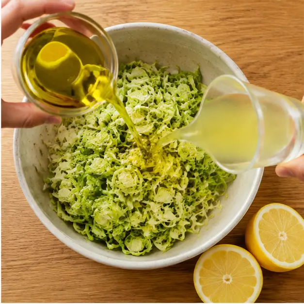 Step 2: Pouring olive oil and Meyer lemon juice over the shredded sprouts