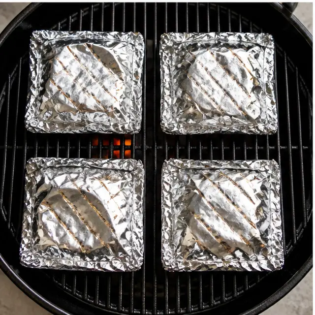 Step 3: Grilling the sealed foil packets on a preheated medium-high grill for 25 to 30 minutes