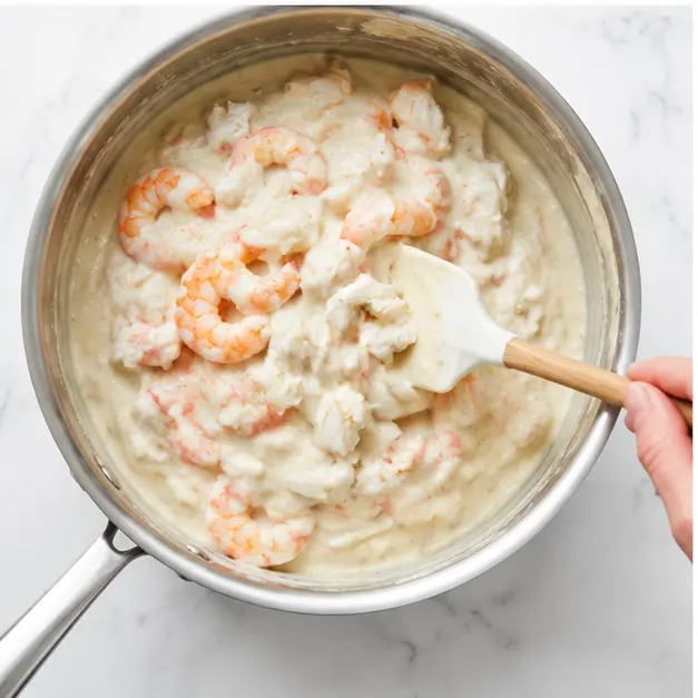 Step 3: Folding crab and shrimp into the cheese sauce