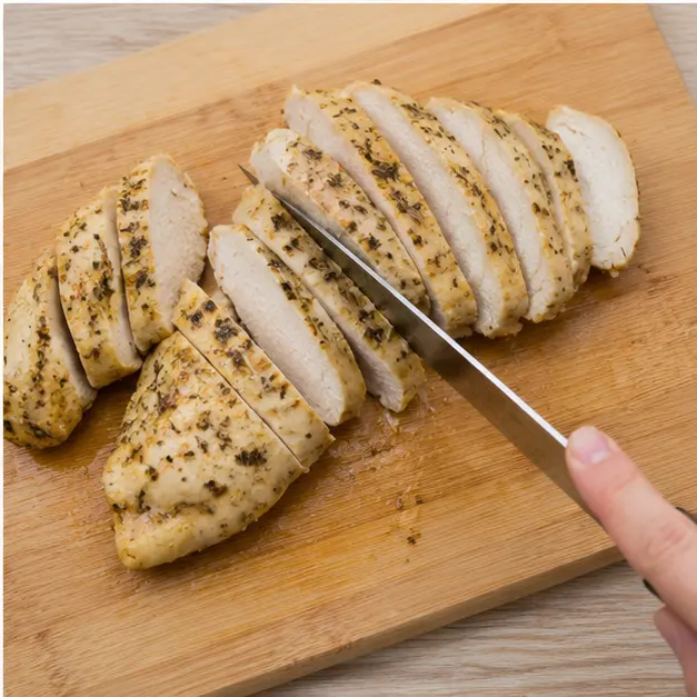 Step 4: Resting and slicing herb-flecked chicken fillets to show the juicy interior