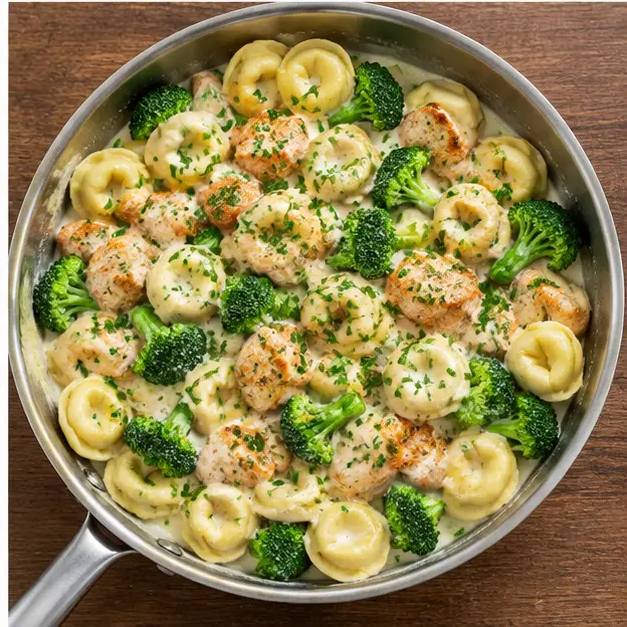 Step 4: Toss cheese tortellini, seared chicken pieces and broccoli florets in the cream sauce
