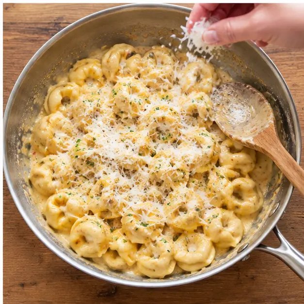 Step 4: Melting in finely grated Parmesan until the sauce turns smooth, glossy and clings to every piece